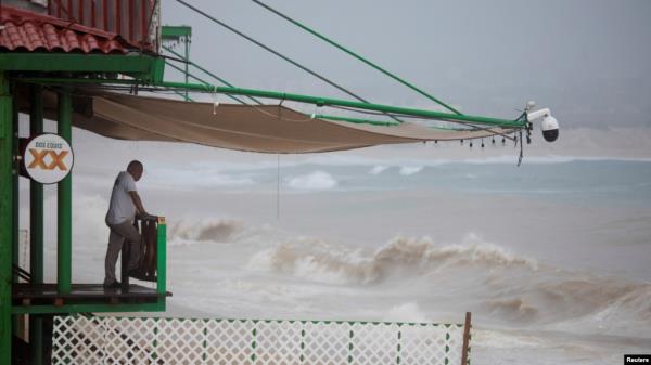 A man looks at the waves of the sea before the arrival of Tropical Storm Ileana, in Cabo San Lucas, Baja California Sur state, Mexico, on Sept. 13, 2024.