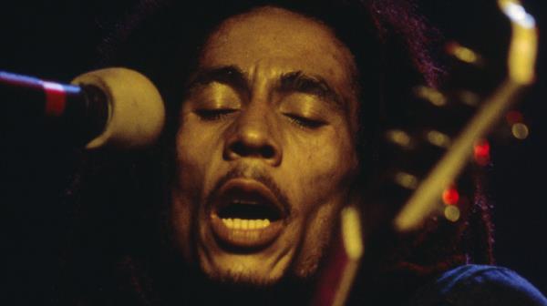 bob marley playing guitar