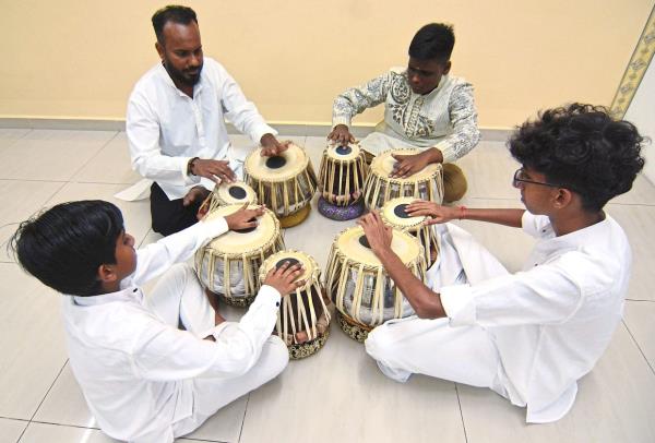 Megenthiran (top left) observes a growing interest among students learning to play the tabla. 