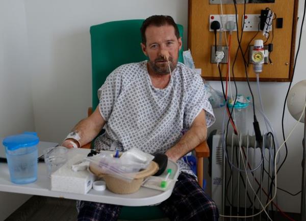 Robert sitting on a chair in his hospital room